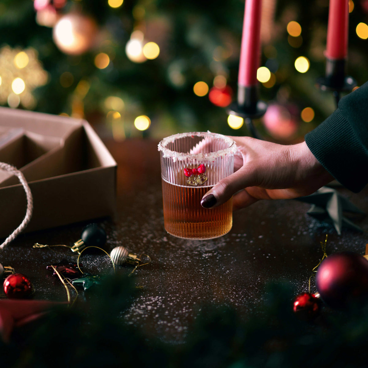 a hand holding a glass of liquid